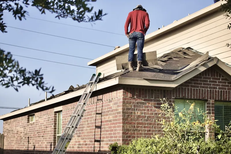 Professional roofer working on a residential roof in Bentonville